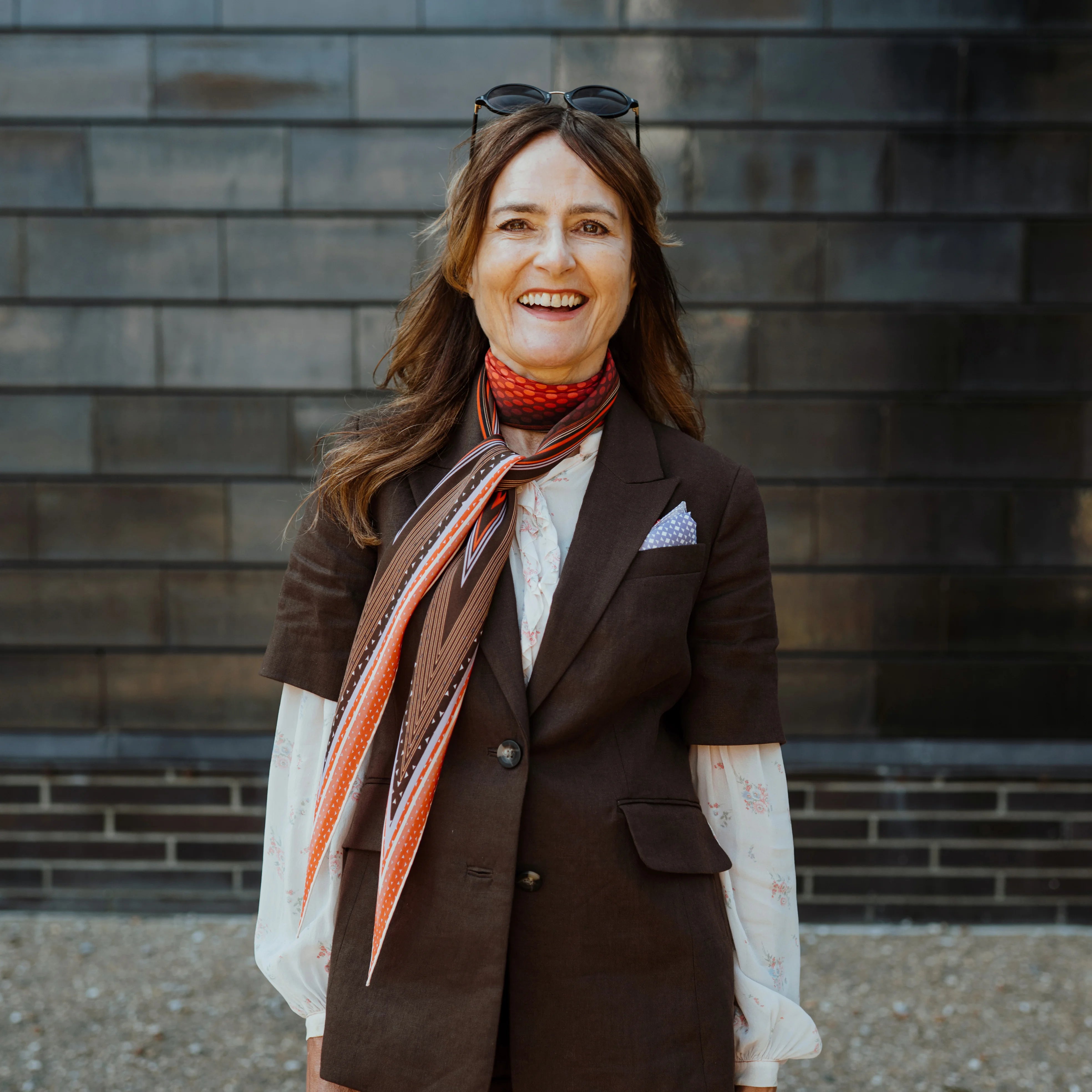 Melanie Laslett is pictured against the Hastings Contemporary wearing the Laslett Diamond scarf looped once around the neck.