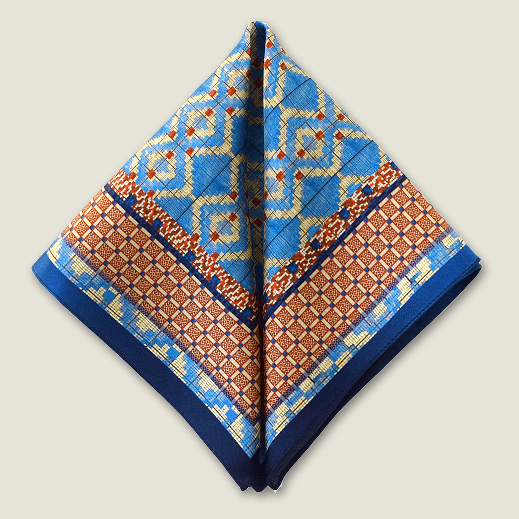100% silk Aztec Blue Pocket Square in blue by Laslett England. Square is shown folded into a triangle shape.
