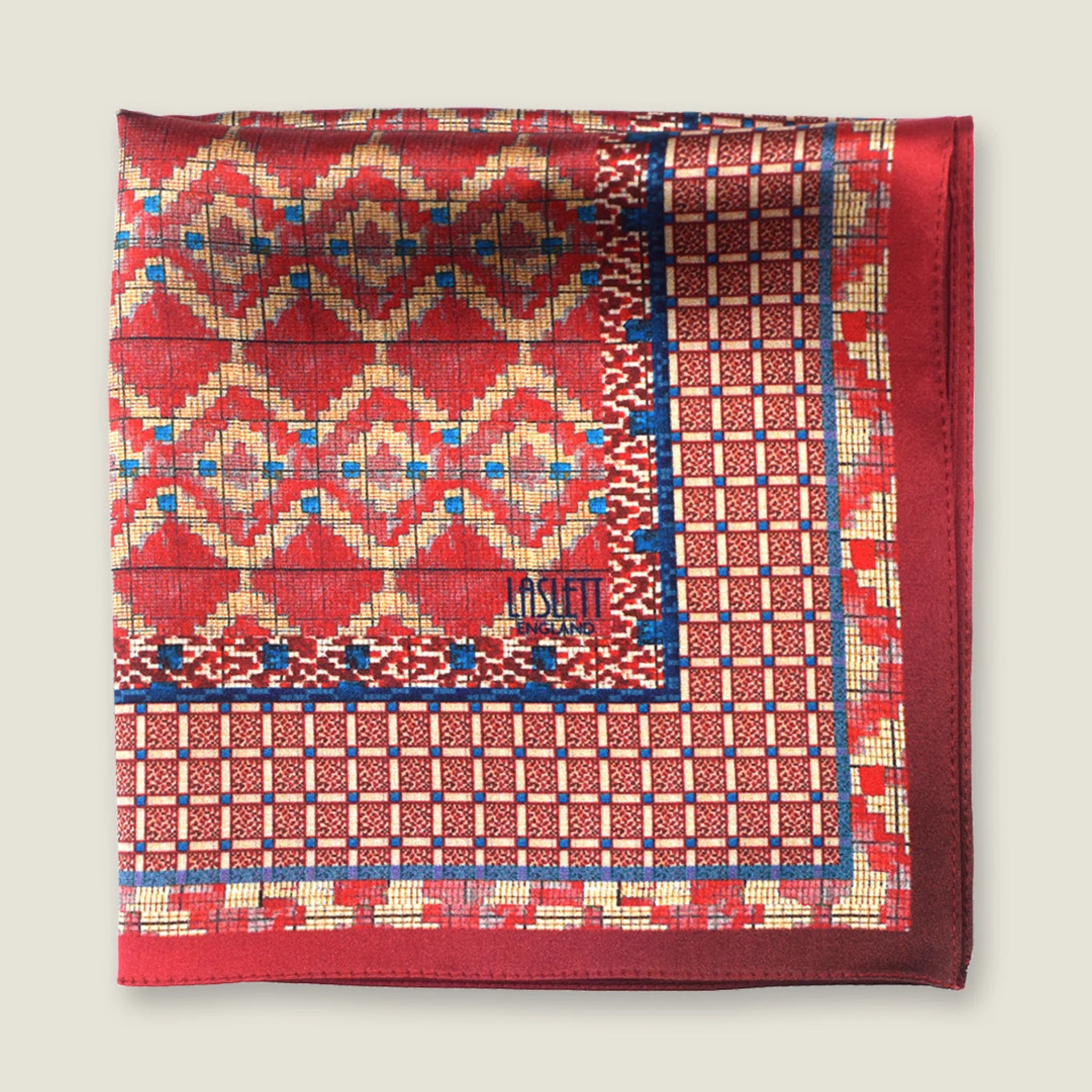 Laslett England Aztec Red pocket square flat lay, red ground with geometric Aztec repeat and navy border detail