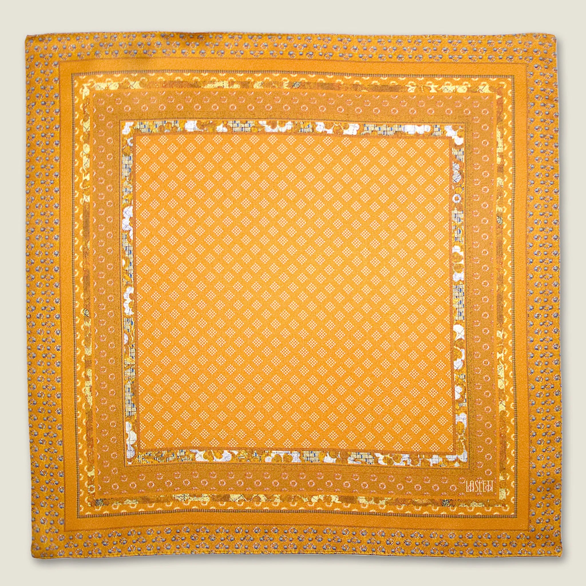 Batik Patchwork Gold pocket square in gold with an intricate patchwork of geometric patterns. Scarf is shown in the signature red Laslett England box.