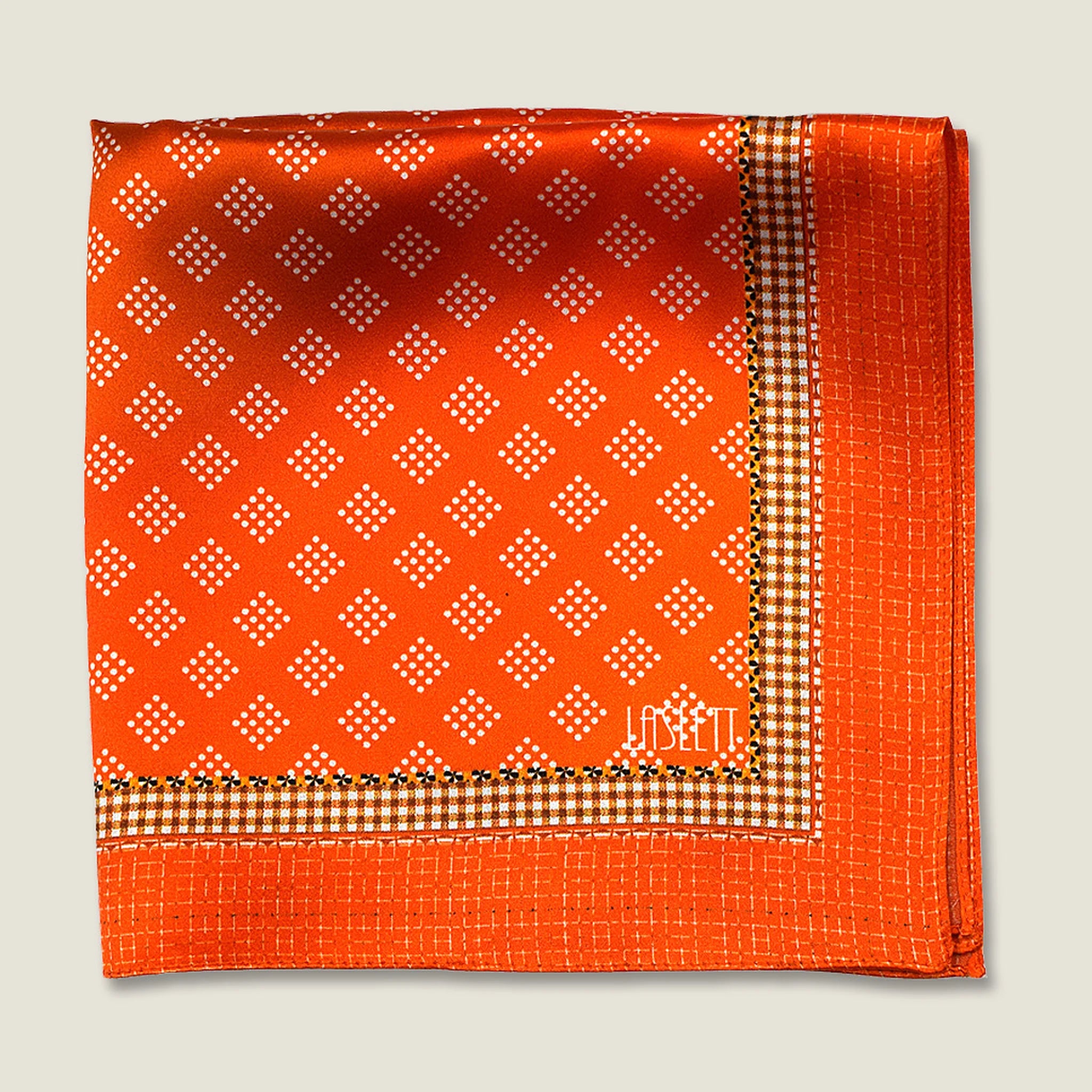 Batik orange pocket square shown folded in four with the Laslett logo showing in flat lay.