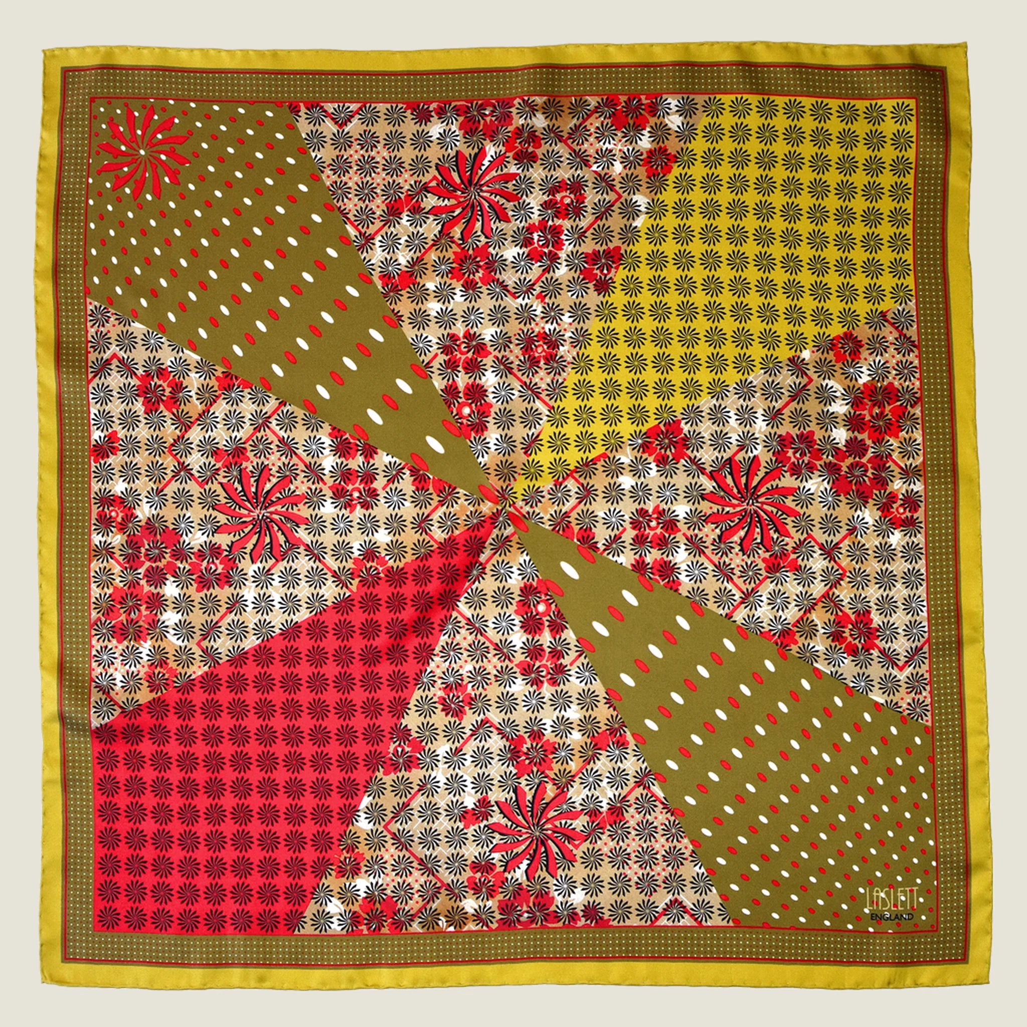 Laslett England Cadiz Silk Bandana flat lay showing all eight radiating sections with stylised florals, spots and geometric patterns in camel, olive, red and mustard gold.