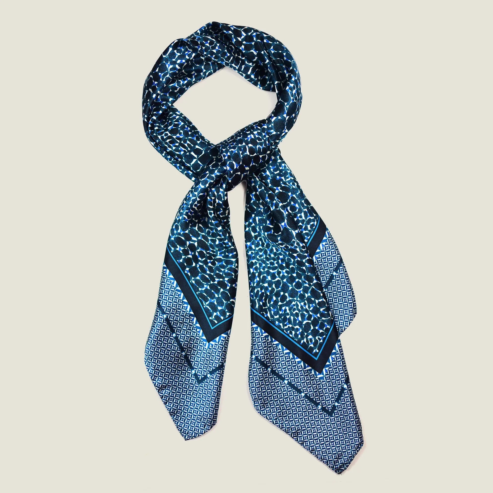 Laslett England silk scarf knotted and styled, Camo Indigo Classic Square in navy and indigo print.