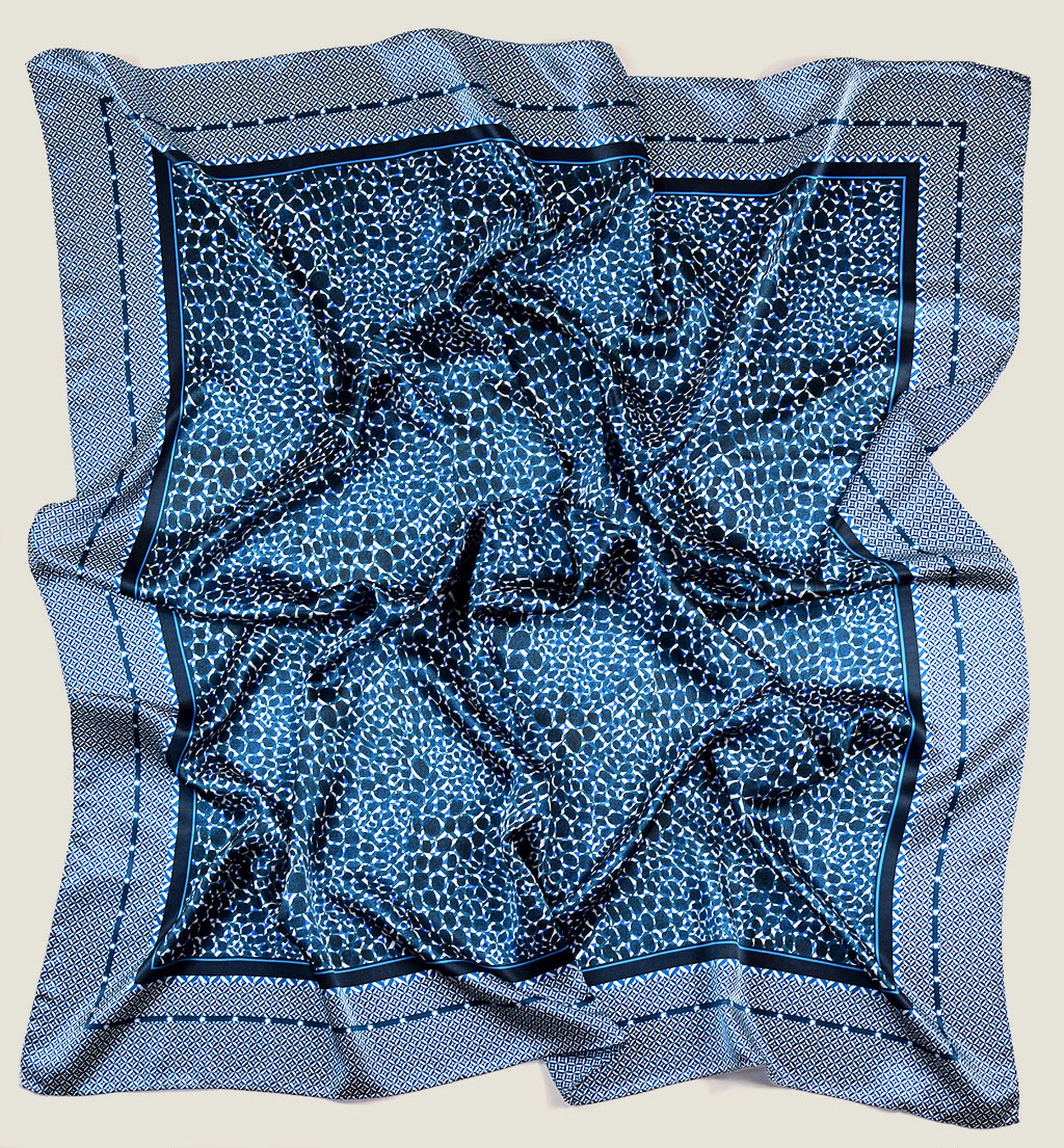 Laslett England Camo Indigo Classic Square knotted as neckerchief, navy and indigo print on cream background. Shown in flat lay.