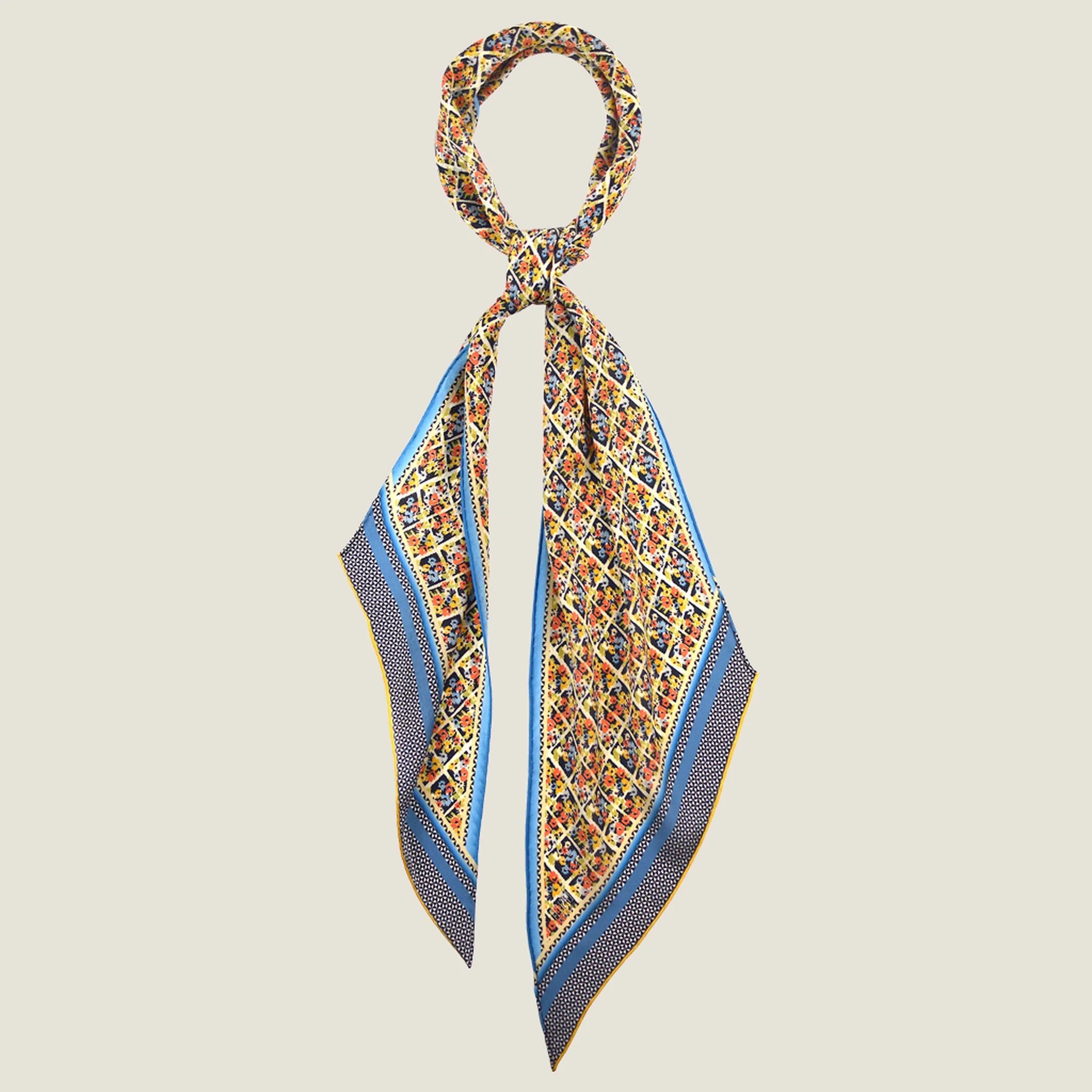 100% silk Laura Chiffon Stole in blue and yellow floral by Laslett England. Shown knotted at the neck.