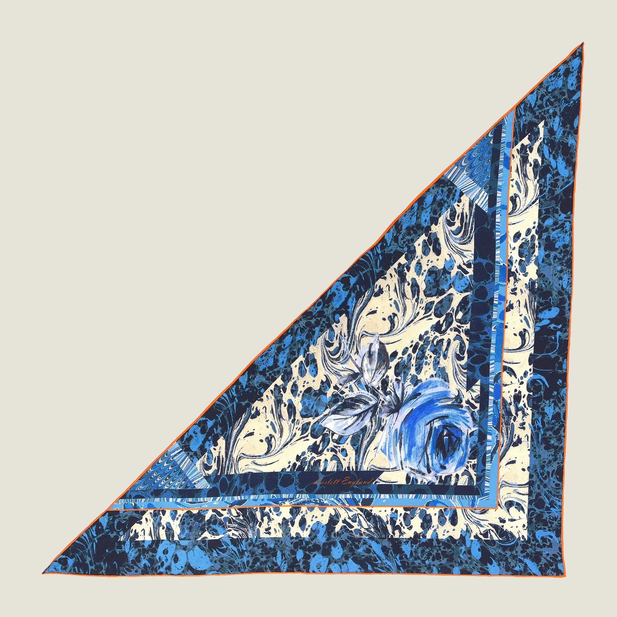 100% silk Marble Rose Triangle Scarf in blue by Laslett England. Pictured laid flat against a neutral background.