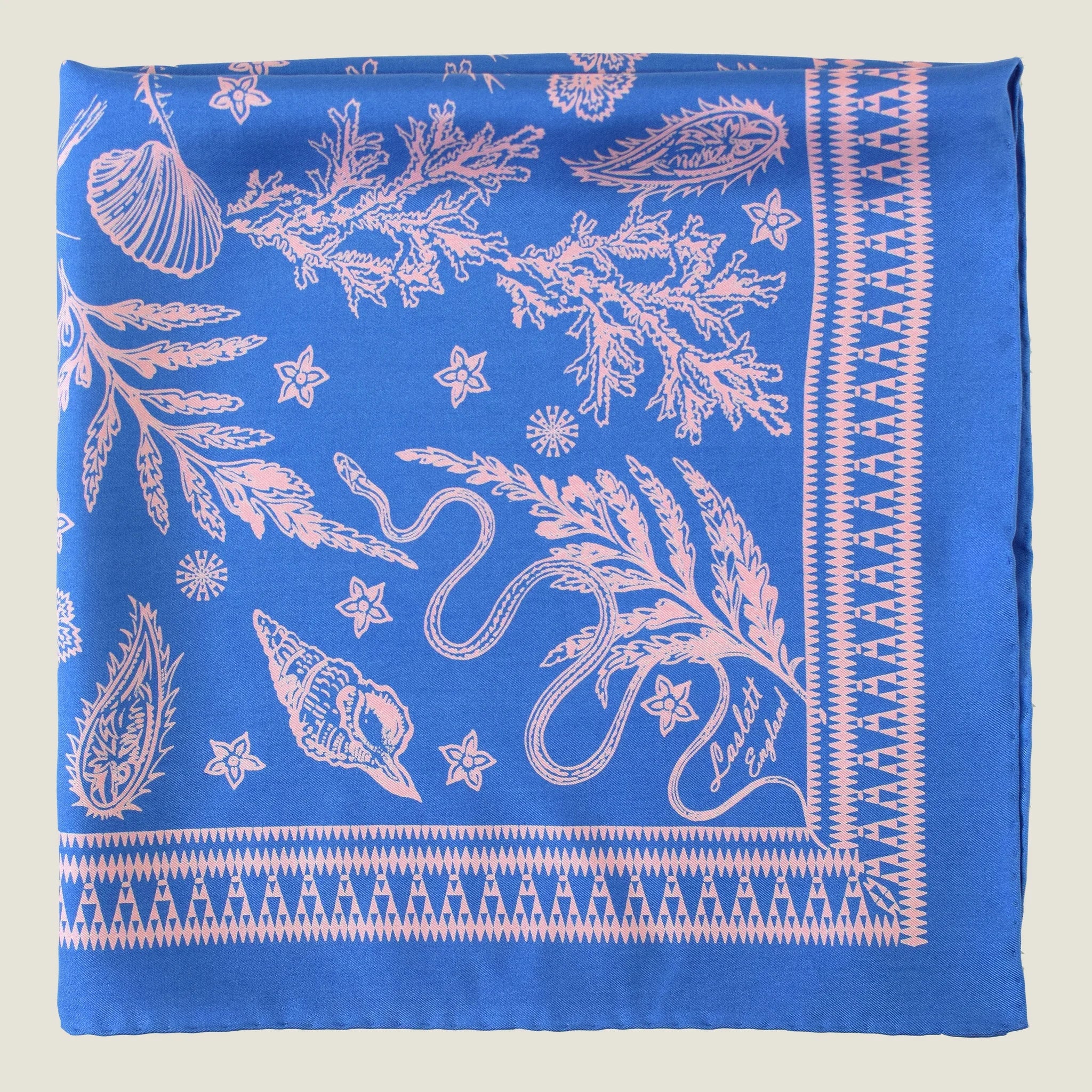 Laslett England Marettimo Cornflower Blue Bandana folded in a flat lay on a neutral background. The pink pattern is inspired by botanical and coastal elements.