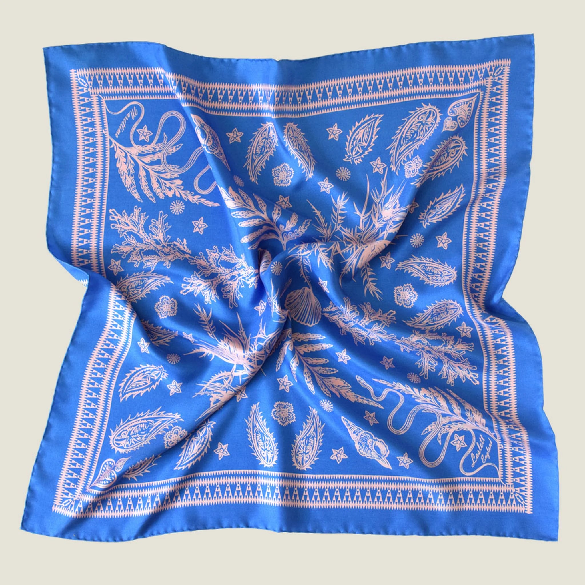 Laslett England Marettimo Cornflower Blue Bandana in a flat lay. The pink pattern is inspired by botanical and coastal elements.