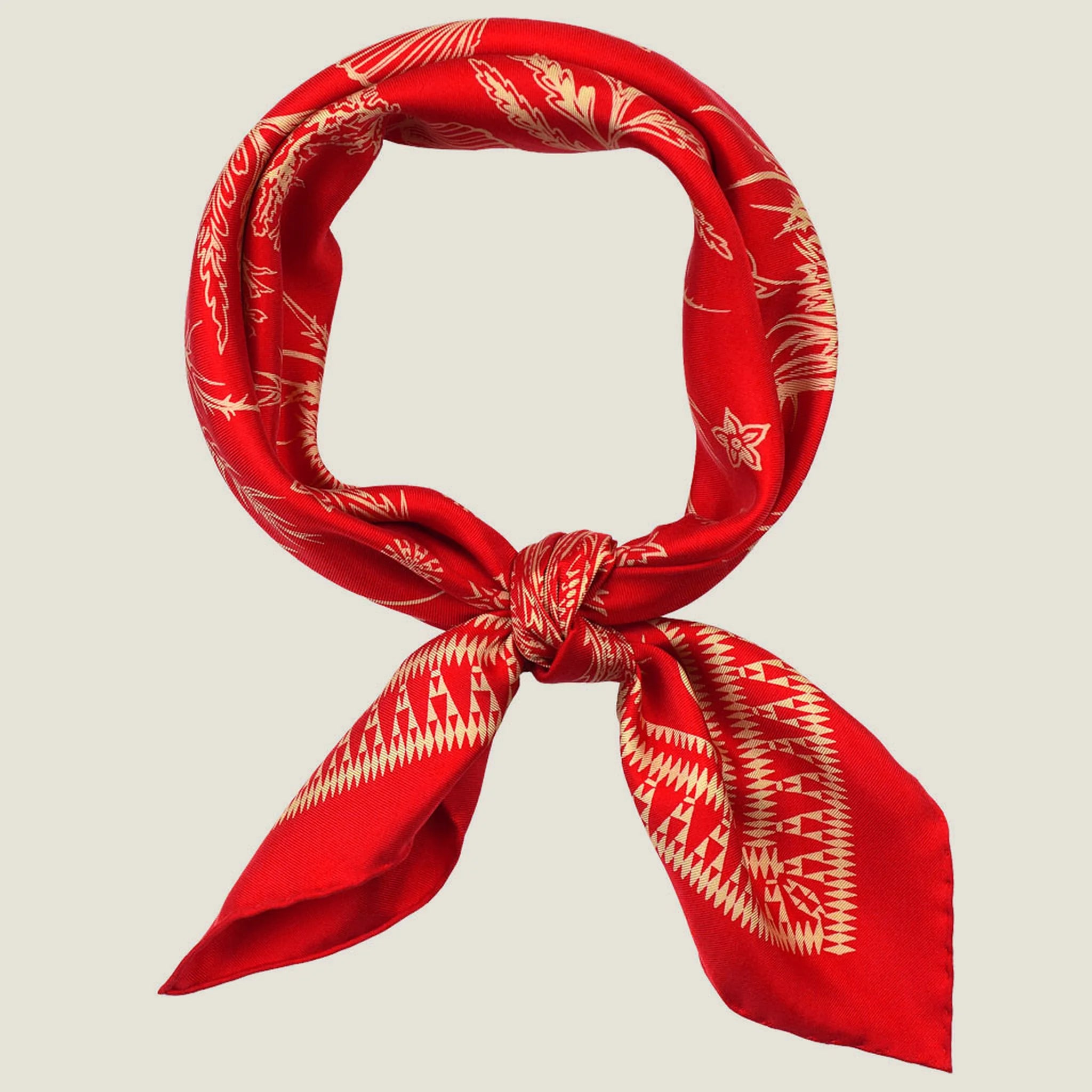 100% silk Marettimo Red Silk Bandana in red by Laslett England. Shown tied together at the front against a neutral background.