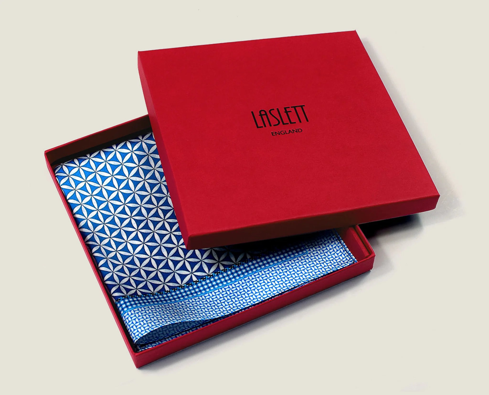 100% silk Moresque Blue Pocket Square in blue by Laslett England. Square is shown packaged in the red signature box.