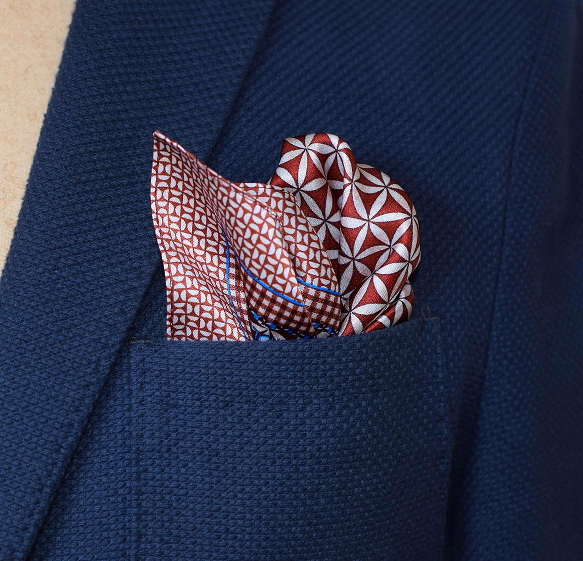 100% silk Moresque Bronze Pocket Square in bronze by Laslett England shown in a blue suit pocket.