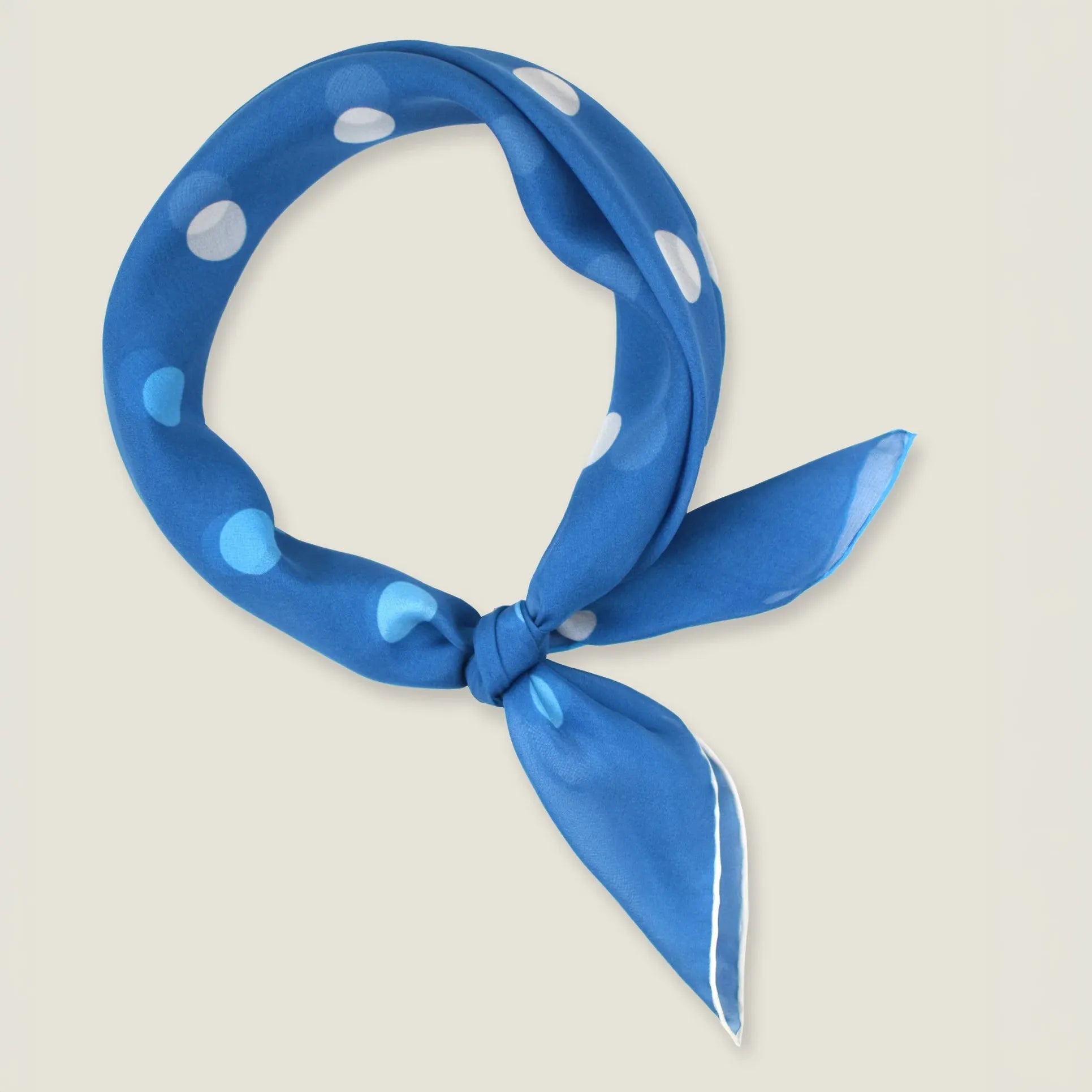 100% silk Solitaire Spot Blue Chiffon in blue by Laslett England. Product shot with the scarf tied in front.