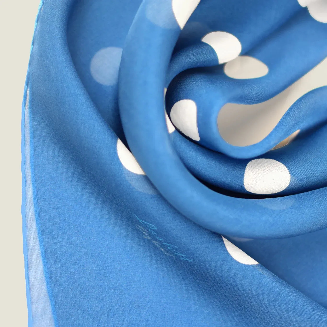 100% silk Solitaire Spot Blue Chiffon in blue by Laslett England. Product shot showing the scarf in close-up.