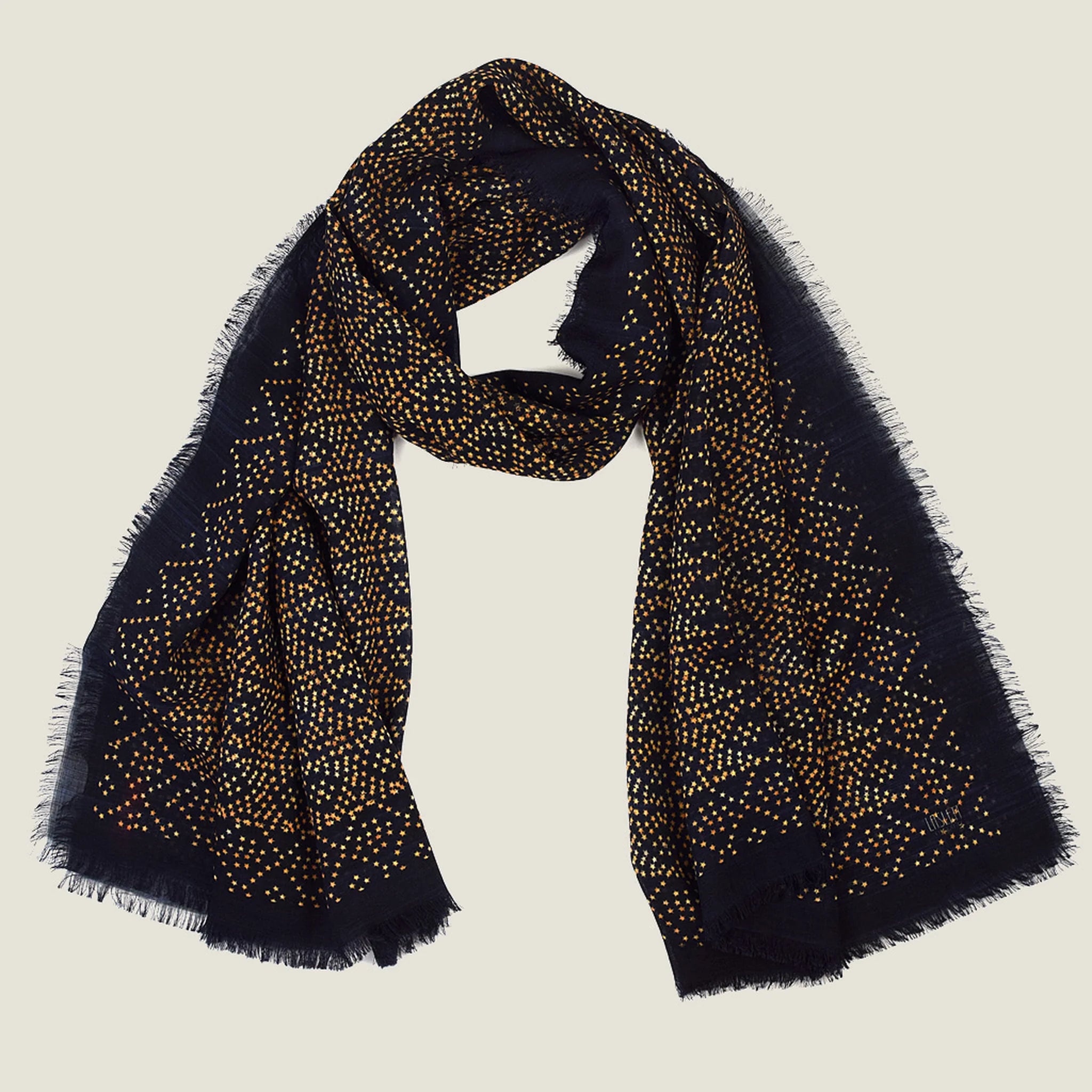 Laslett England Starry Midnight Laslett Wrap flat lay, 120cm x 180cm superfine wool in deep blue-black ground with bronze micro-star print and hand-fringed hem