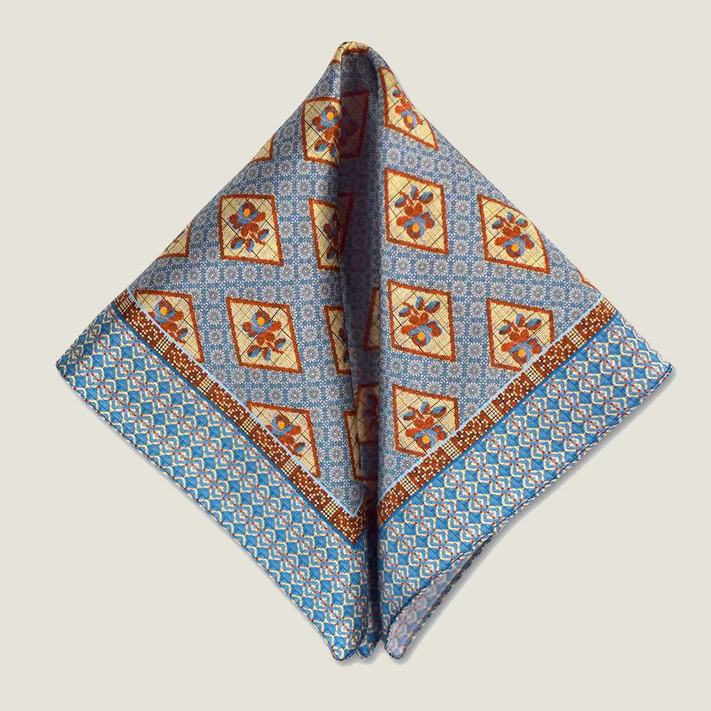 Laslett England Tapestry Rose pocket square folded flat, showing full print repeat in sky blue and terracotta with scarf folded into two triangles.