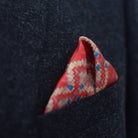 Laslett England Aztec Red pocket square worn in navy suit breast pocket, red geometric print with multiple pocket points