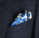 Laslett England Oval Spot Navy pocket square worn in dark suit breast pocket, cream and navy spot print