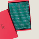 Laslett England Revival Teal Silk Oblong folded in gift box, showing blush pink triangle dot print on deep teal green 100% silk twill with pin-fringed hem