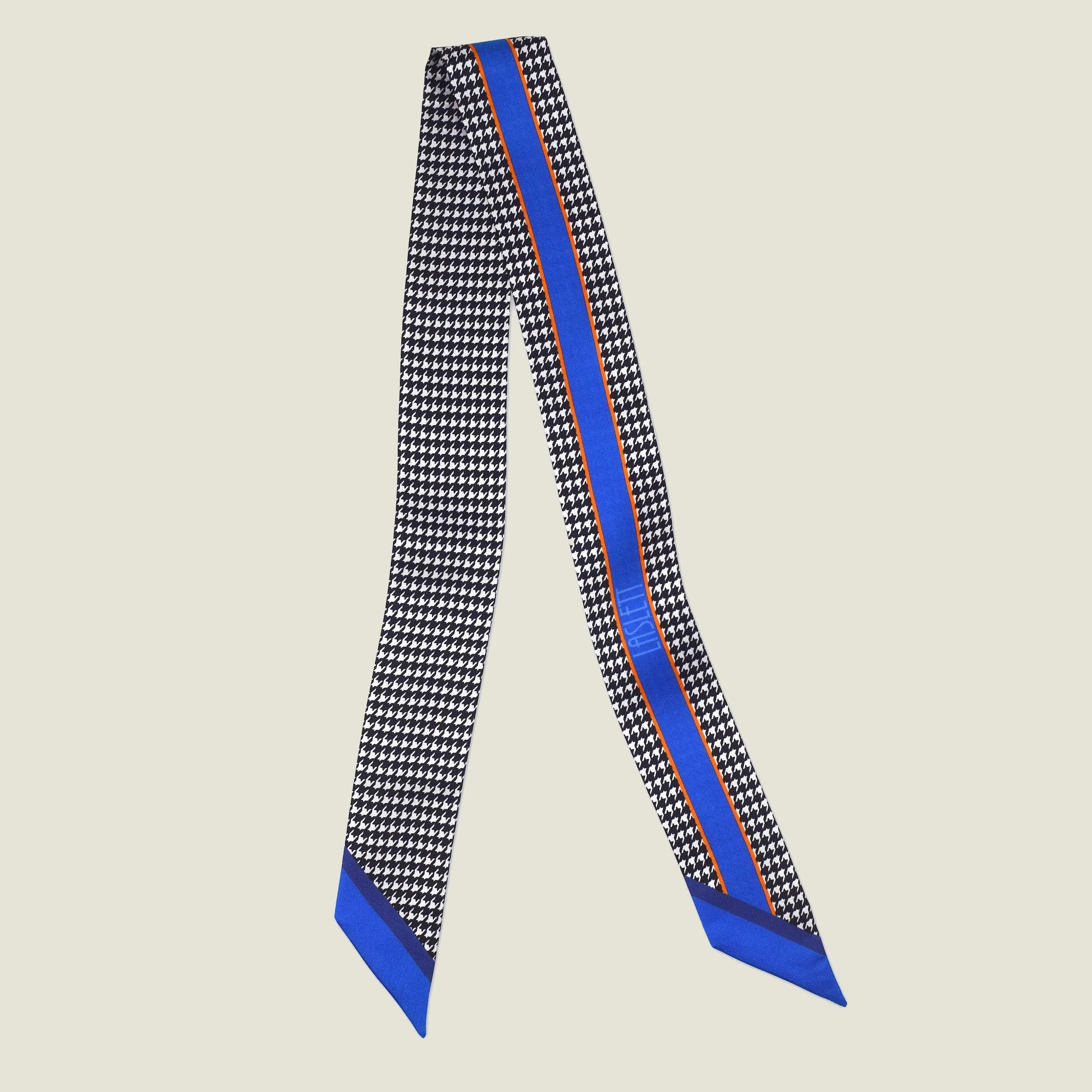 100% silk Dogtooth Blue Laslett Ribbon in black and blue by Laslett England. Ribbon is pictured folded in two to show the contrasting pattern. 