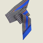 100% silk Dogtooth Blue Laslett Ribbon in black and blue by Laslett England. Ribbon is pictured folded over into three in flat lay. 