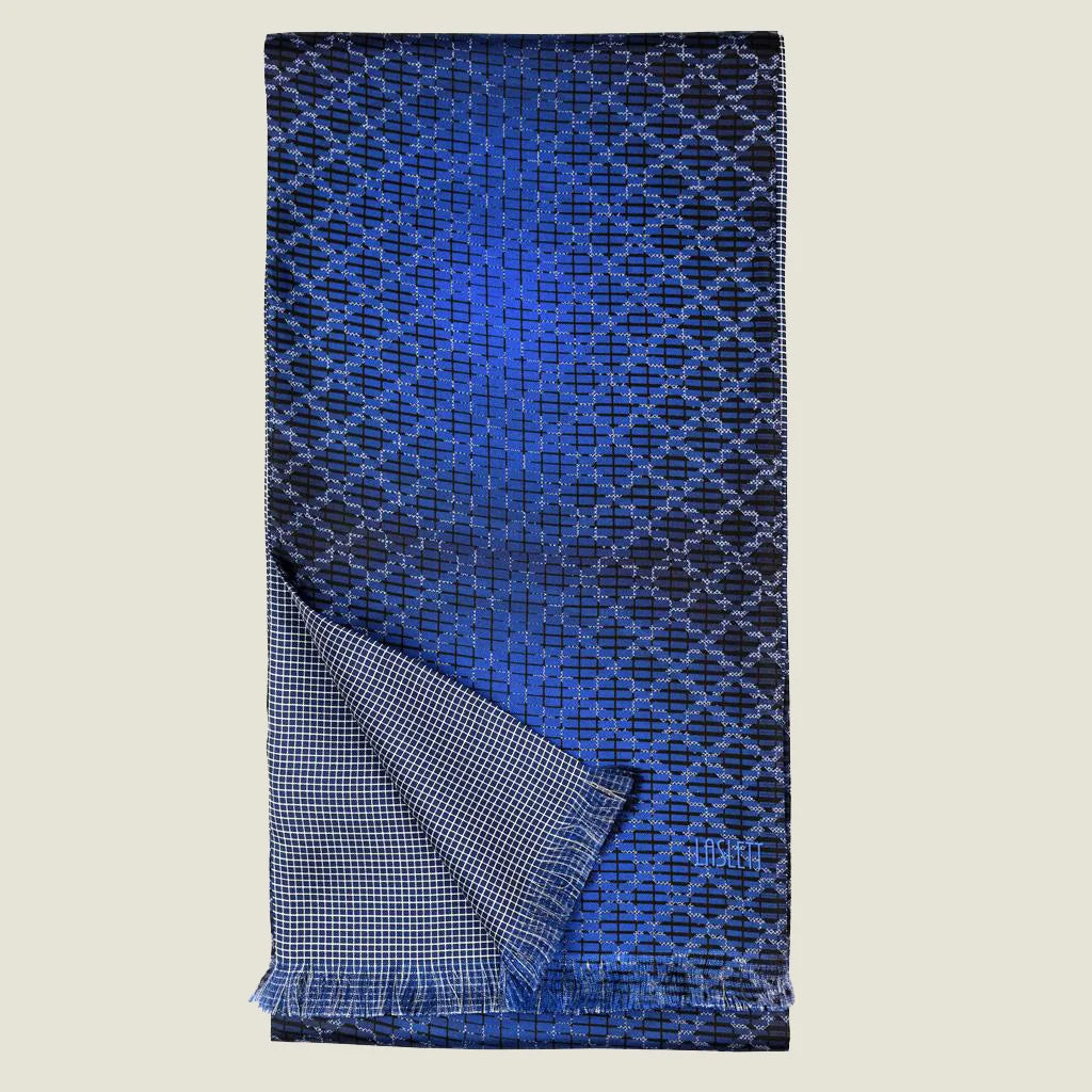 Laslett England Lapis Blue silk oblong folded in half with a turned corner to show the contrasting geometric pattern on each side. 