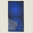 Laslett England Lapis Blue silk oblong folded in half with a turned corner to show the contrasting geometric pattern on each side. 