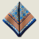 100% silk Aztec Blue Pocket Square in blue by Laslett England. Square is shown folded into a triangle shape. 