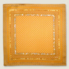 Batik Patchwork Gold pocket square in gold with an intricate patchwork of geometric patterns. Scarf is shown in the signature red Laslett England box. 