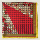 Laslett England Cadiz Silk Bandana folded flat showing camel floral and red spot sections of multi-pattern radiating print.
