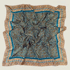 Laslett England classic square silk scarf flat lay, teal and bronze animal print with hand-rolled edge.