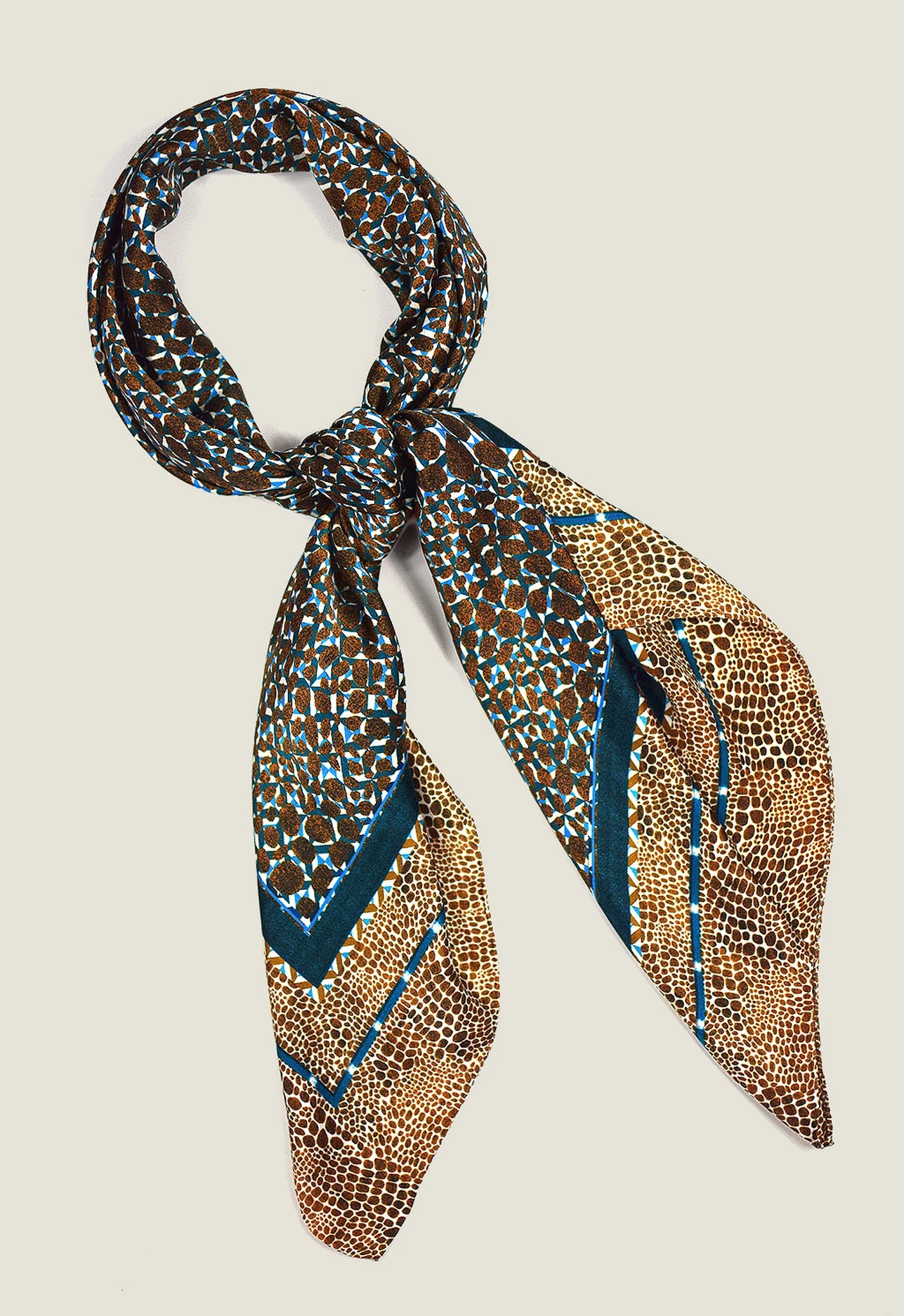 Laslett England classic square silk scarf knotted, teal and bronze print styled as neckerchief.