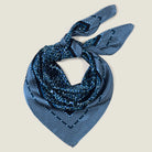 Laslett England Camo Indigo Classic Square knotted as neckerchief, navy and indigo print on cream background.