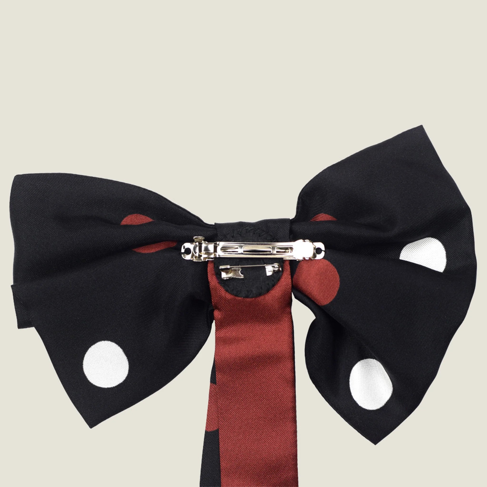 100% silk Coco Silk Bow in black; red by Laslett England. Photographed in reverse to show the brooch fastening and barette. 