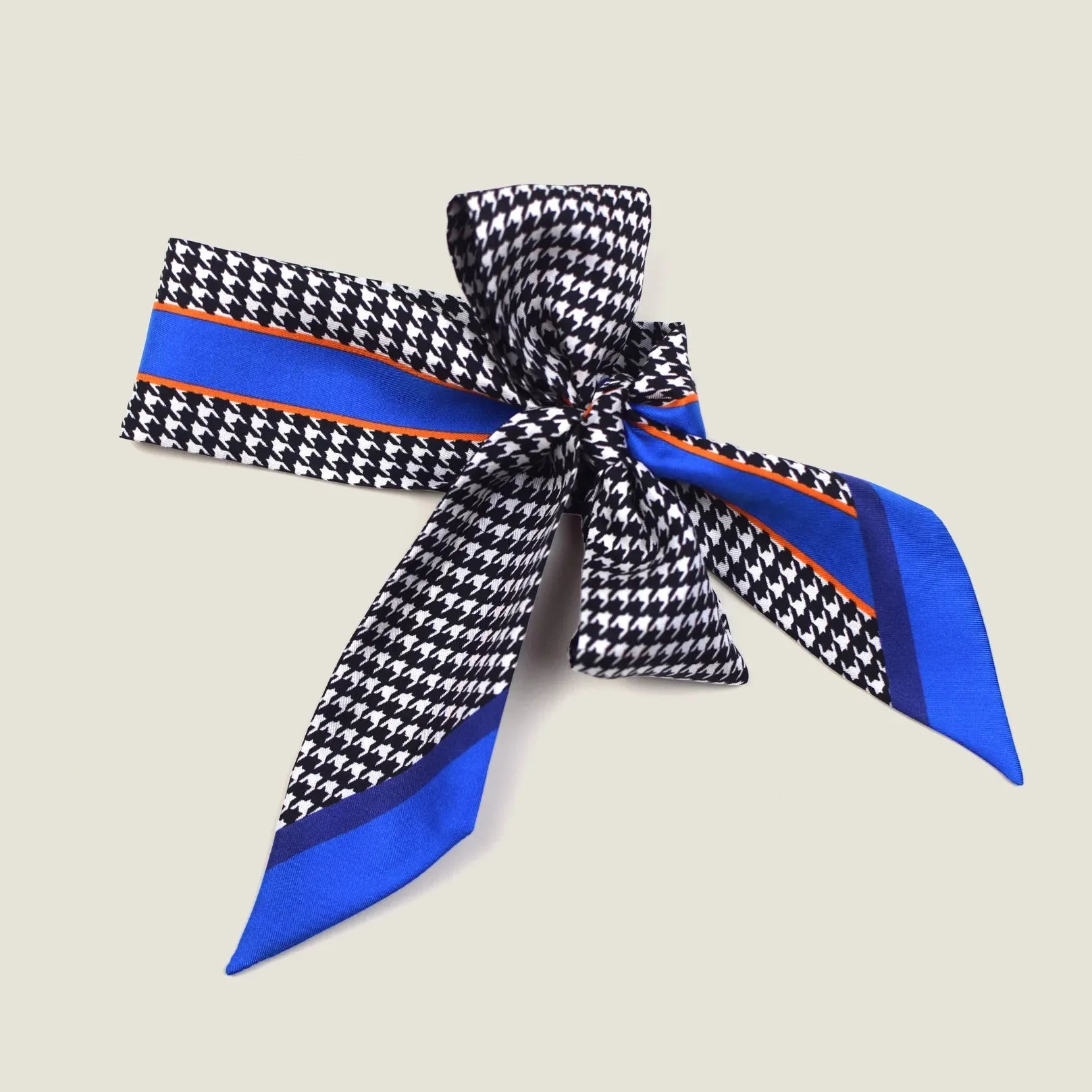 100% silk Dogtooth Blue Laslett Ribbon in black and blue by Laslett England. Ribbon is shown tied into a bow and displayed against a neutral background. 