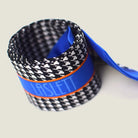 100% silk Dogtooth Blue Laslett Ribbon in black and blue by Laslett England. Ribbon is shown rolled up neatly to show the 'Laslett' signature. 