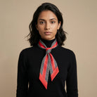 100% silk Dogtooth Red Laslett Ribbon in black and red by Laslett England. Knotted around the model's neck so that it drapes over the chest. 