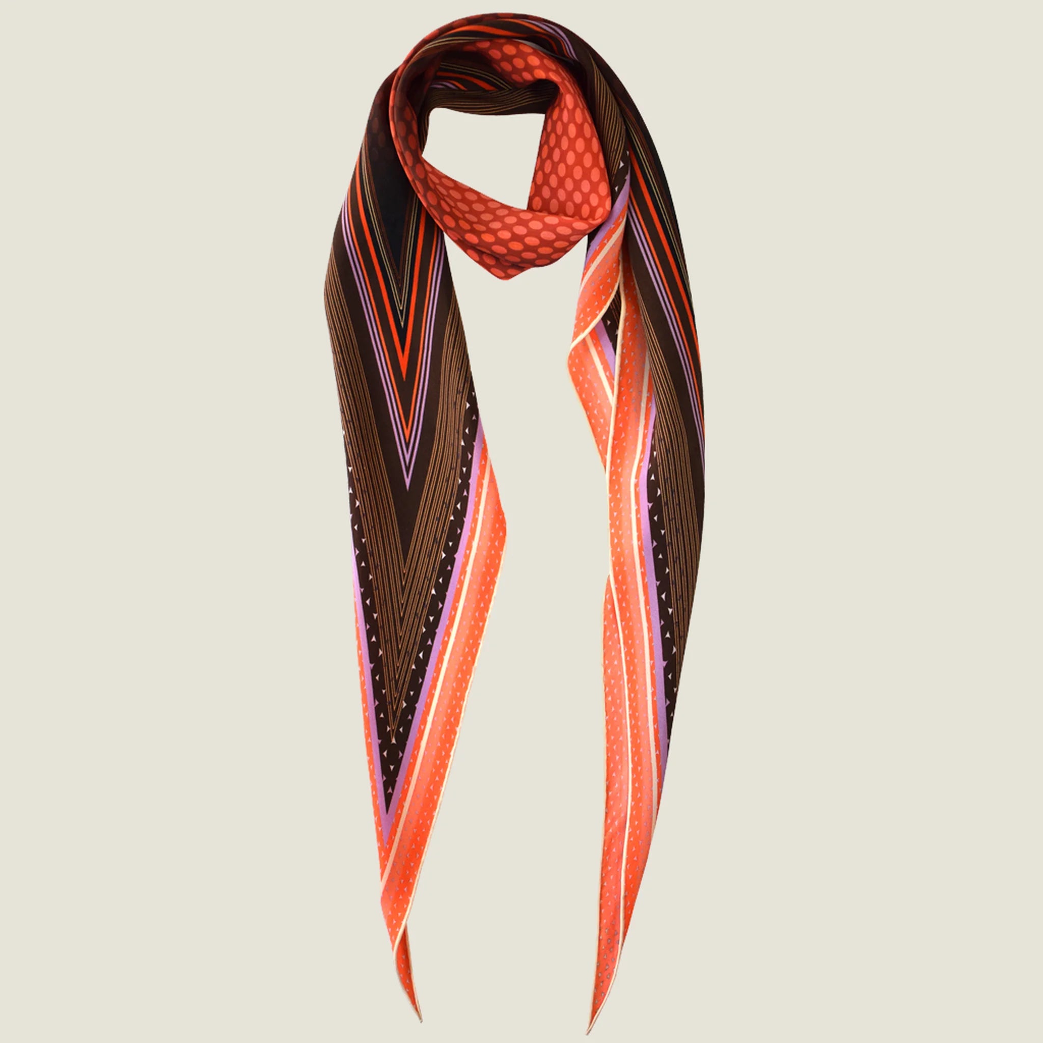 100% silk Dream Coral Laslett Diamond in orange and brown by Laslett England. Pictured against a neutral background looped once around the neck. 