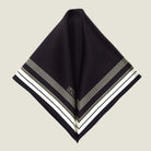 Laslett England Gambit Ivory pocket square folded flat into two triangles, showing full black ground with ivory border. 