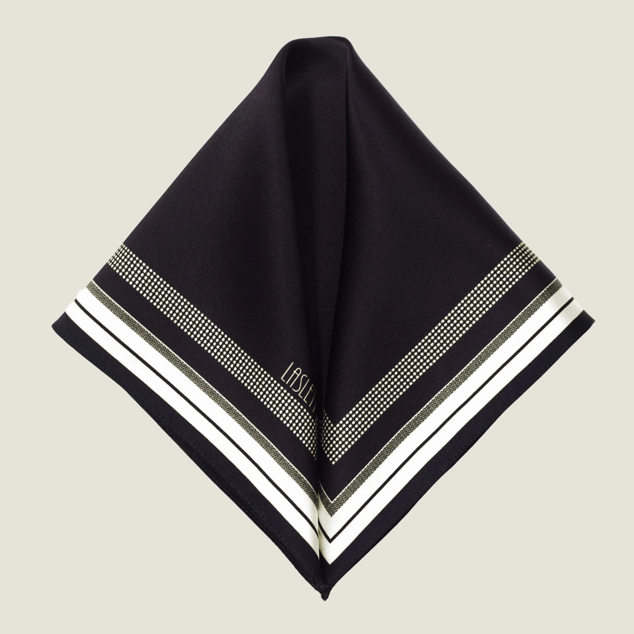 Laslett England Gambit Ivory pocket square folded flat into two triangles, showing full black ground with ivory border. 