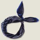 Laslett England Houston Midnight Silk Bandana knotted and styled, showing midnight blue radial stripe print on 100% silk twill.