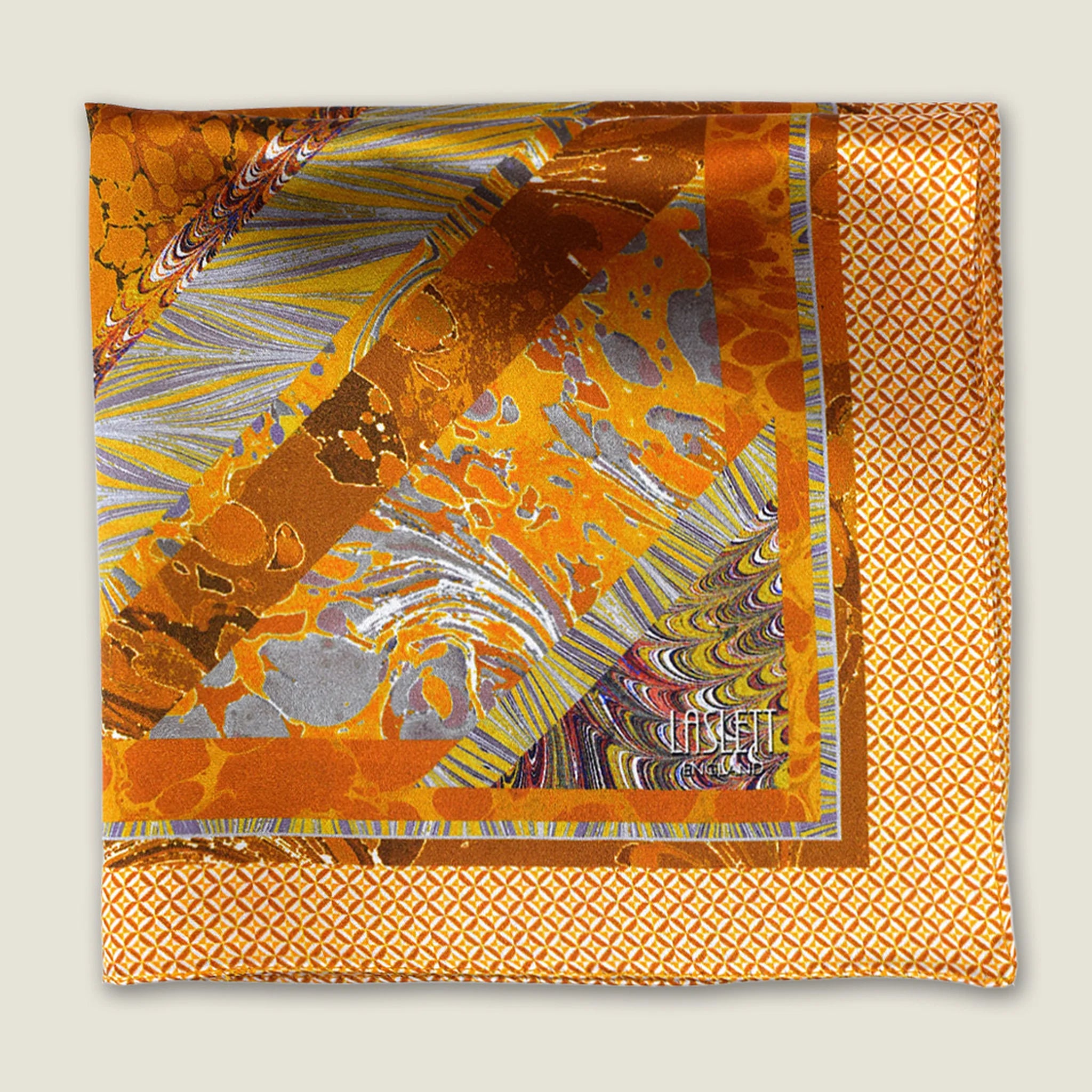 100% silk Marble Amber pocket square is inspired by the decorative marbled papers found inside antique and fine books. Shown folded into four against a neutral background. 