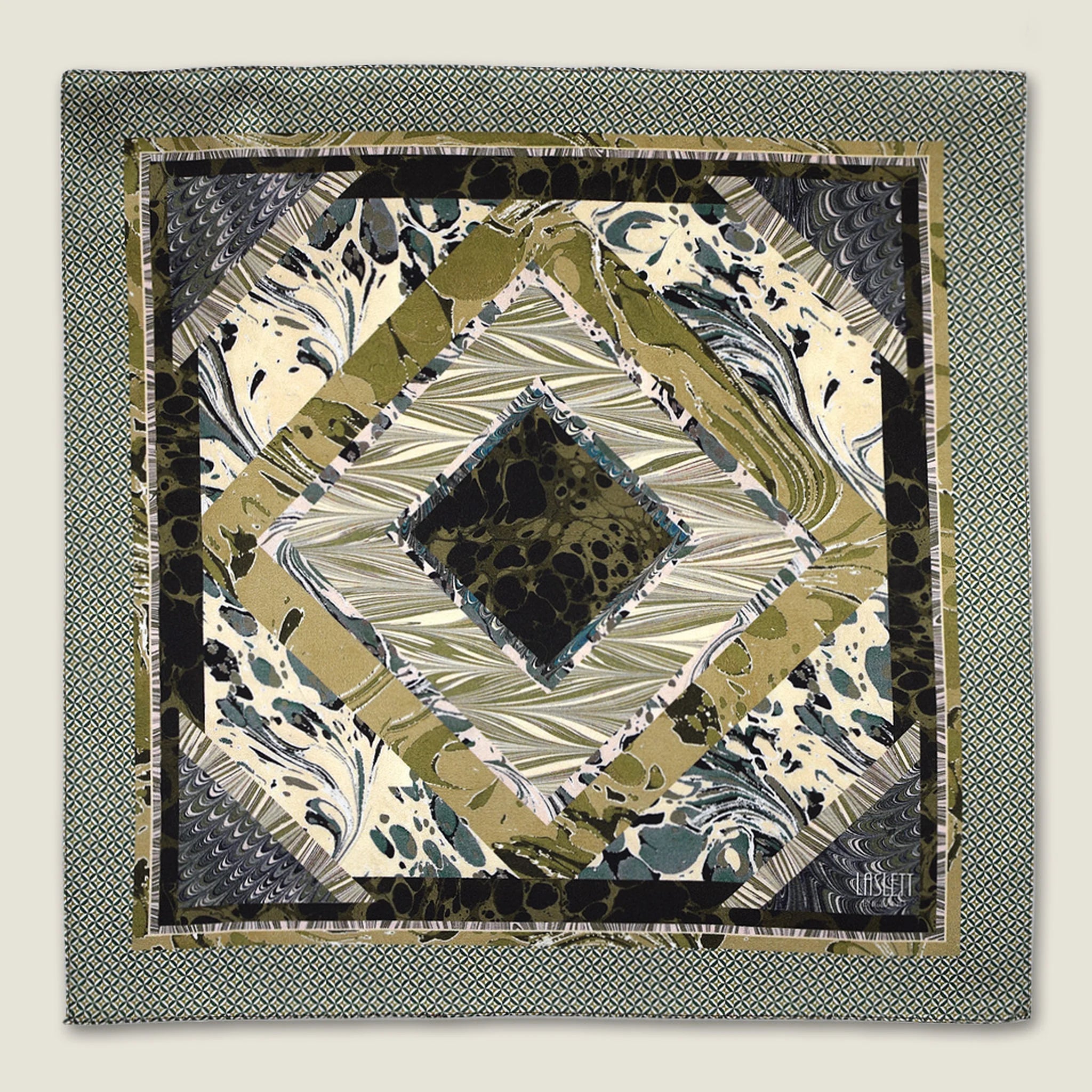 This Marble Camo pocket square applies the flowing, layered quality of traditional hand-marbling to a palette of olive green, teal, black and ivory. Photographed in flat lay. 