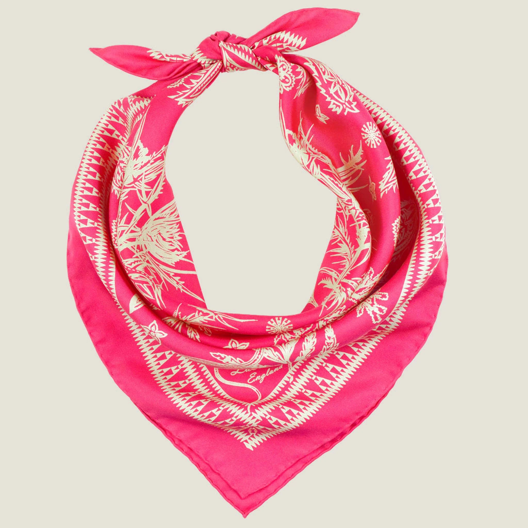 Laslett England Marettimo Cerise Silk Bandana knotted cowboy style showing cerise pink with cream discharge-printed coastal motifs on silk twill.
