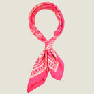 Laslett England Marettimo Cerise Silk Bandana knotted at neck close view, cerise pink silk twill with cream discharge botanical print.