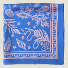 Laslett England Marettimo Cornflower Blue Bandana folded in a flat lay on a neutral background. The pink pattern is inspired by botanical and coastal elements. 