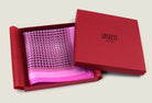 This Matrix Pink pocket square has a striking geometric design that reveals, on closer inspection, repeating graphic lines and patterns. In soft dusty pink with charcoal and white, square is shown in the signature red gift box. 