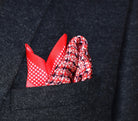 100% Matrix Red pocket square has a geometric design with a floral repeat that reveals itself on closer inspection. Square is shown arranged into a charcoal suit jacket. 
