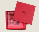 100% Matrix Red pocket square has a geometric design with a floral repeat that reveals itself on closer inspection. Square is shown boxed in a red signature box. 