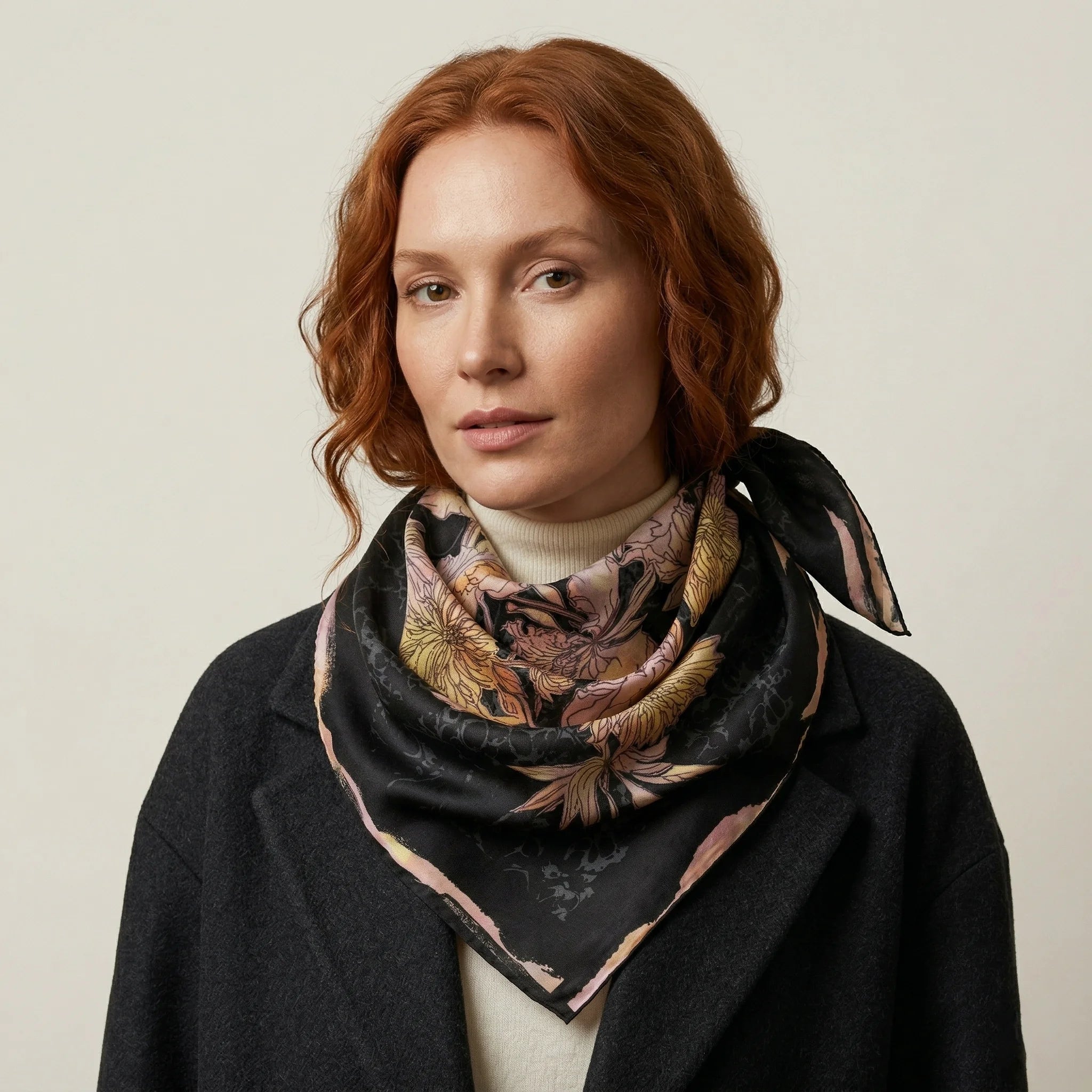 Midnight Rose classic square silk scarf worn loosely tied at the neck, styled with a dark coat — Laslett England