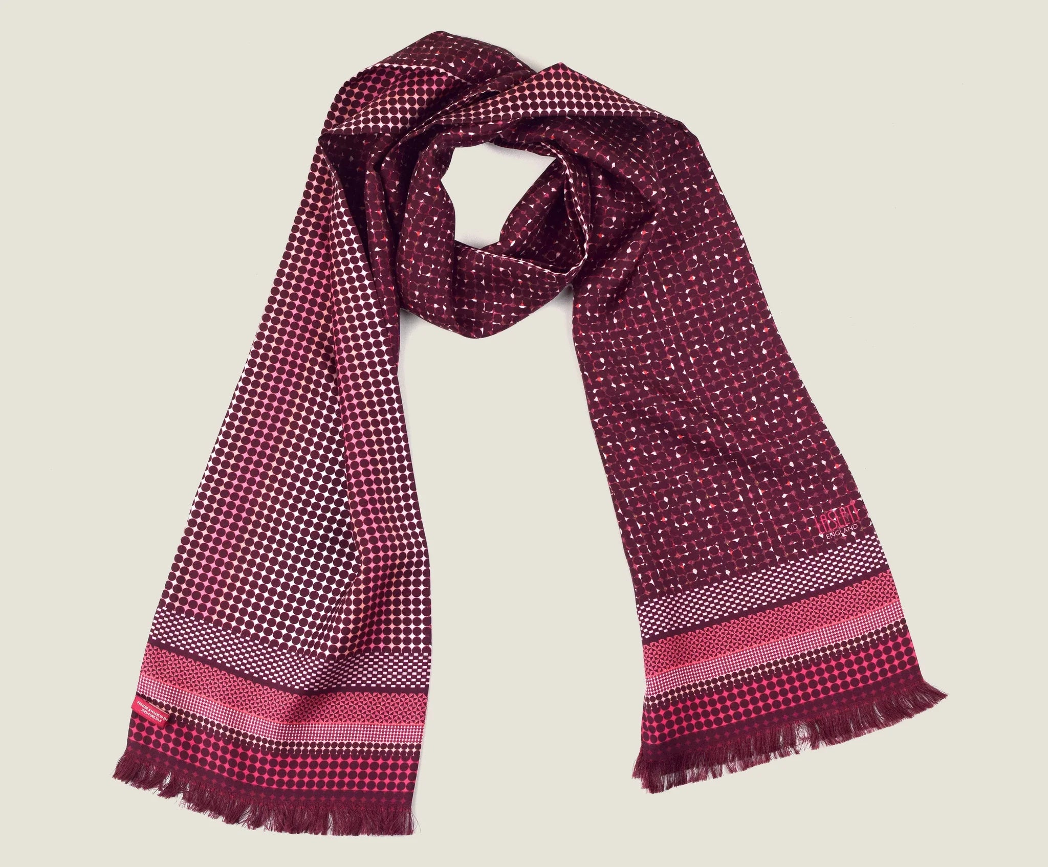 Laslett England Monaco Burgundy Silk Oblong flat lay, 21cm x 165cm double-sided silk twill in deep burgundy with white and pink dot print and stripe border, pin-fringed hem.